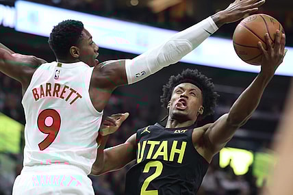 Jan 12, 2024; Salt Lake City, Utah, USA; Utah Jazz guard Collin Sexton (2) goes to the basket against Toronto Raptors guard RJ Barrett (9) during the first quarter at Delta Center. Mandatory Credit: Rob Gray-USA TODAY Sports