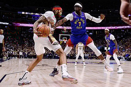 Jan 12, 2024; Denver, Colorado, USA; New Orleans Pelicans forward Brandon Ingram (14) controls the ball under pressure from Denver Nuggets guard Reggie Jackson (7) in the first quarter at Ball Arena. Mandatory Credit: Isaiah J. Downing-USA TODAY Sports