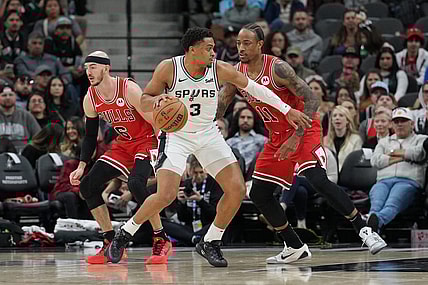 Jan 13, 2024; San Antonio, Texas, USA;  San Antonio Spurs forward Keldon Johnson (3) dribbles against Chicago Bulls forward DeMar DeRozan (11) in the first half at Frost Bank Center. Mandatory Credit: Daniel Dunn-USA TODAY Sports