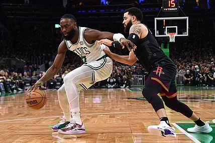 Jan 13, 2024; Boston, Massachusetts, USA; Boston Celtics guard Jaylen Brown (7) controls the ball while Houston Rockets guard Fred VanVleet (5) defends during the first half at TD Garden. Mandatory Credit: Bob DeChiara-USA TODAY Sports