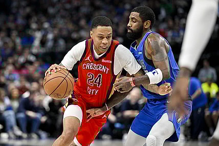 Jan 13, 2024; Dallas, Texas, USA; New Orleans Pelicans guard Jordan Hawkins (24) drives to the basket past Dallas Mavericks guard Kyrie Irving (11) during the second half at the American Airlines Center. Mandatory Credit: Jerome Miron-USA TODAY Sports
