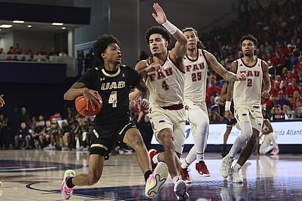 Jan 14, 2024; Boca Raton, Florida, USA; UAB Blazers guard Eric Gaines (4) drives to the basket against Florida Atlantic Owls guard Bryan Greenlee (4) during the first half at Eleanor R. Baldwin Arena. Mandatory Credit: Sam Navarro-USA TODAY Sports