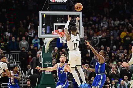 Jan 14, 2024; Milwaukee, Wisconsin, USA; Milwaukee Bucks guard Damian Lillard (0) scores the game-winning three-point basket at the end of overtime against the Sacramento Kings at Fiserv Forum. Mandatory Credit: Benny Sieu-USA TODAY Sports