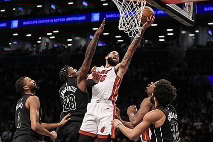 Jan 15, 2024; Brooklyn, New York, USA;  Miami Heat forward Caleb Martin (16) drives past Brooklyn Nets forward Dorian Finney-Smith (28) for a layup in the second quarter at Barclays Center. Mandatory Credit: Wendell Cruz-USA TODAY Sports