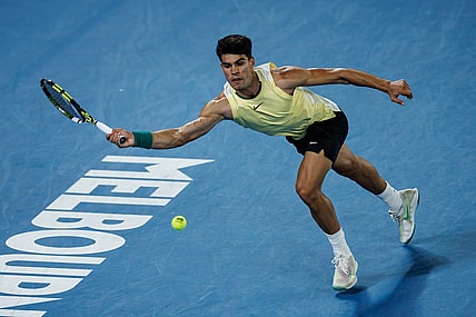 Jan 16, 2024; Melbourne, Victoria, Australia;   Carlos Alcaraz of Spain hits a shot against Richard Gasquet of France in the first round of the men s singles at the Australian Open. Mandatory Credit: Mike Frey-USA TODAY Sports