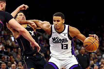 Jan 16, 2024; Phoenix, Arizona, USA; Sacramento Kings forward Keegan Murray (13) drives to the basket against Phoenix Suns guard Devin Booker (1) during the third quarter at Footprint Center. Mandatory Credit: Mark J. Rebilas-USA TODAY Sports