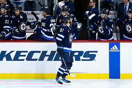 Jan 16, 2024; Winnipeg, Manitoba, CAN; Winnipeg Jets forward Kyle Connor (81) is congratulated by his teammates on his goal against the New York Islanders during the third period at Canada Life Centre. Mandatory Credit: Terrence Lee-USA TODAY Sports