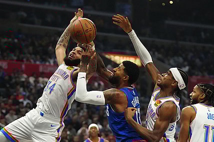 Jan 16, 2024; Los Angeles, California, USA; Oklahoma City Thunder forward Kenrich Williams (34) and guard Shai Gilgeous-Alexander (2) battle for the ball with LA Clippers forward Paul George (13) in the first half at Crypto.com Arena. Mandatory Credit: Kirby Lee-USA TODAY Sports
