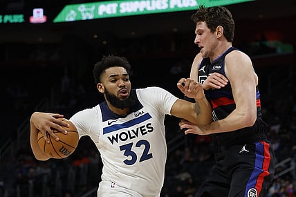 Jan 17, 2024; Detroit, Michigan, USA;  Minnesota Timberwolves center Karl-Anthony Towns (32) is defended by Detroit Pistons forward MikeMuscala (41) in the first half at Little Caesars Arena. Mandatory Credit: Rick Osentoski-USA TODAY Sports