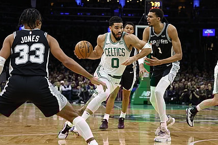 Jan 17, 2024; Boston, Massachusetts, USA; Boston Celtics forward Jayson Tatum (0) drives past San Antonio Spurs center Victor Wembanyama (1) during the second quarter at TD Garden. Mandatory Credit: Winslow Townson-USA TODAY Sports