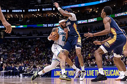 Jan 17, 2024; New Orleans, Louisiana, USA; Charlotte Hornets forward Miles Bridges (0) dribbles against New Orleans Pelicans forward Brandon Ingram (14) during the second half at Smoothie King Center. Mandatory Credit: Stephen Lew-USA TODAY Sports