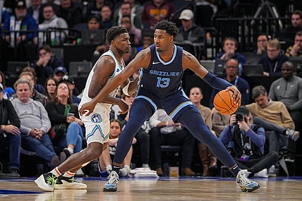 Jan 18, 2024; Minneapolis, Minnesota, USA; Minnesota Timberwolves guard Anthony Edwards (5) defends the Memphis Grizzlies forward Jaren Jackson Jr. (13) in the second quarter at Target Center. Mandatory Credit: Brad Rempel-USA TODAY Sports