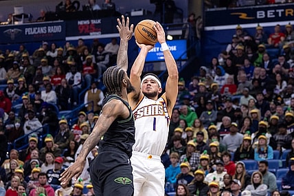 Jan 19, 2024; New Orleans, Louisiana, USA;  Phoenix Suns guard Devin Booker (1) shoots against New Orleans Pelicans forward Naji Marshall (8) during the first half at Smoothie King Center. Mandatory Credit: Stephen Lew-USA TODAY Sports