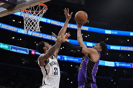 Jan 19, 2024; Los Angeles, California, USA; Los Angeles Lakers forward Christian Wood (35) shoots the ball against Brooklyn Nets center Nic Claxton (33) in the first half at Crypto.com Arena. Mandatory Credit: Kirby Lee-USA TODAY Sports