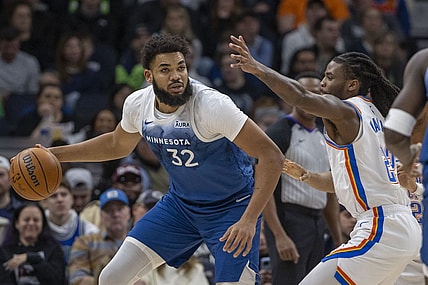 Jan 20, 2024; Minneapolis, Minnesota, USA; Minnesota Timberwolves center Karl-Anthony Towns (32) dribbles the ball and looks to pass Oklahoma City Thunder guard Cason Wallace (22) plays defense in the first half at Target Center. Mandatory Credit: Jesse Johnson-USA TODAY Sports