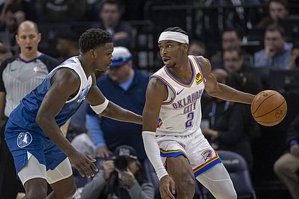 Jan 20, 2024; Minneapolis, Minnesota, USA; Oklahoma City Thunder guard Shai Gilgeous-Alexander (2) looks to pass the ball as Minnesota Timberwolves guard Anthony Edwards (5) plays defense in the second half at Target Center. Mandatory Credit: Jesse Johnson-USA TODAY Sports