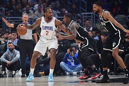 Jan 21, 2024; Los Angeles, California, USA; Los Angeles Clippers forward Kawhi Leonard (2) controls the ball against Brooklyn Nets forward Dorian Finney-Smith (28) and forward Mikal Bridges (1) during the first half at Crypto.com Arena. Mandatory Credit: Gary A. Vasquez-USA TODAY Sports