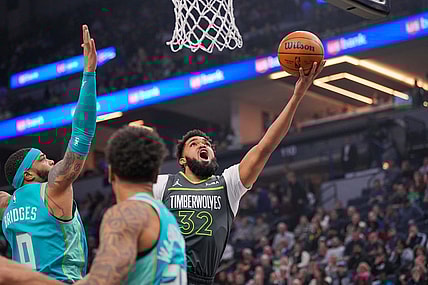 Jan 22, 2024; Minneapolis, Minnesota, USA; Minnesota Timberwolves center Karl-Anthony Towns (32) shoots against the Charlotte Hornets in the first quarter at Target Center. Mandatory Credit: Brad Rempel-USA TODAY Sports
