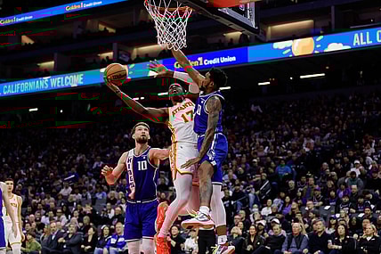 Jan 22, 2024; Sacramento, California, USA; Atlanta Hawks forward Onyeka Okongwu (17) drives to the basket against  Sacramento Kings guard Malik Monk (0) during the second quarter at Golden 1 Center. Mandatory Credit: Sergio Estrada-USA TODAY Sports