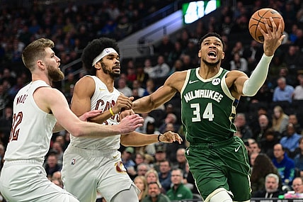 Jan 24, 2024; Milwaukee, Wisconsin, USA;  Milwaukee Bucks forward Giannis Antetokounmpo (34) takes a shot against Cleveland Cavaliers forward Dean Wade (32) and center Jarrett Allen (31) in the first quarter at Fiserv Forum. Mandatory Credit: Benny Sieu-USA TODAY Sports