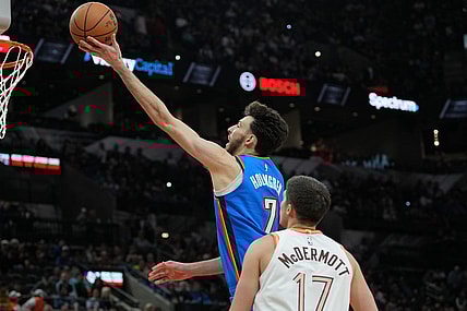 Jan 24, 2024; San Antonio, Texas, USA;  Oklahoma City Thunder forward Chet Holmgren (7) shoots in front of San Antonio Spurs forward Doug McDermott (17) in the second half at Frost Bank Center. Mandatory Credit: Daniel Dunn-USA TODAY Sports