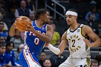Jan 25, 2024; Indianapolis, Indiana, USA; Philadelphia 76ers guard Tyrese Maxey (0) drives to the basket while Indiana Pacers guard Andrew Nembhard (2) defends in the first half at Gainbridge Fieldhouse. Mandatory Credit: Trevor Ruszkowski-USA TODAY Sports