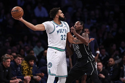 Jan 25, 2024; Brooklyn, New York, USA; Minnesota Timberwolves center Karl-Anthony Towns (32) shields the ball from Brooklyn Nets forward Dorian Finney-Smith (28) during the first quarter at Barclays Center. Mandatory Credit: Vincent Carchietta-USA TODAY Sports