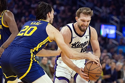 Jan 25, 2024; San Francisco, California, USA; Golden State Warriors center Dario Saric (20) tries to steal the ball from Sacramento Kings forward Domantas Sabonis (10) during the first quarter at Chase Center. Mandatory Credit: D. Ross Cameron-USA TODAY Sports
