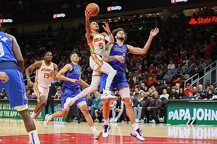 Jan 26, 2024; Atlanta, Georgia, USA; Atlanta Hawks guard Dejounte Murray (5) shoots past Dallas Mavericks center Dereck Lively II (2) in the second half at State Farm Arena. Mandatory Credit: Brett Davis-USA TODAY Sports