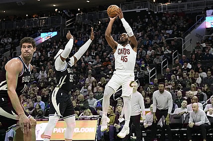 Jan 26, 2024; Milwaukee, Wisconsin, USA;  Cleveland Cavaliers guard Donovan Mitchell (45) shoots against Milwaukee Bucks forward Jae Crowder (99) during the third quarter at Fiserv Forum. Mandatory Credit: Jeff Hanisch-USA TODAY Sports