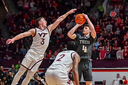 Jan 27, 2024; Blacksburg, Virginia, USA; Georgia Tech Yellow Jackets guard Carter Murphy (4) shoots while being defended by Virginia Tech Hokies guard Sean Pedulla (3) during the first half at Cassell Coliseum. Mandatory Credit: Brian Bishop-USA TODAY Sports