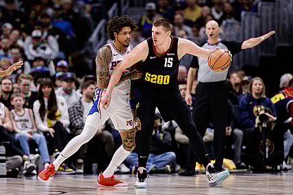Jan 27, 2024; Denver, Colorado, USA; Denver Nuggets center Nikola Jokic (15) controls the ball as Philadelphia 76ers guard Kelly Oubre Jr. (9) guards in the third quarter at Ball Arena. Mandatory Credit: Isaiah J. Downing-USA TODAY Sports