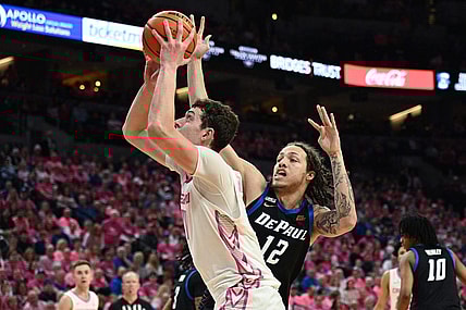 Jan 27, 2024; Omaha, Nebraska, USA; Creighton Bluejays center Ryan Kalkbrenner (11) scores against DePaul Blue Demons forward Mac Etienne (12) in the second half at CHI Health Center Omaha. Mandatory Credit: Steven Branscombe-USA TODAY Sports
