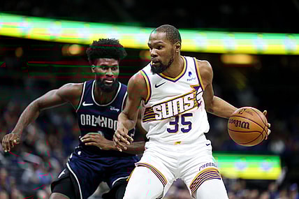 Jan 28, 2024; Orlando, Florida, USA;  Phoenix Suns forward Kevin Durant (35) drives to the hoop past Orlando Magic forward Jonathan Isaac (1) in the second quarter at the Kia Center. Mandatory Credit: Nathan Ray Seebeck-USA TODAY Sports
