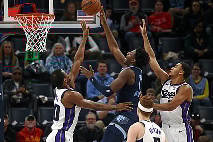Jan 29, 2024; Memphis, Tennessee, USA; Memphis Grizzlies forward-center Jaren Jackson Jr. (13) shoots between Sacramento Kings forward Harrison Barnes (40)and Sacramento Kings forward Keegan Murray (13) during the first half at FedExForum. Mandatory Credit: Petre Thomas-USA TODAY Sports