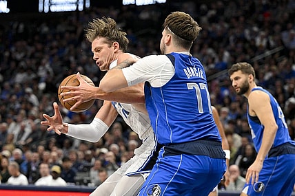 Jan 29, 2024; Dallas, Texas, USA; Dallas Mavericks guard Luka Doncic (77) attempts to knock the ball away from Orlando Magic center Moritz Wagner (21) during the second quarter at the American Airlines Center. Mandatory Credit: Jerome Miron-USA TODAY Sports