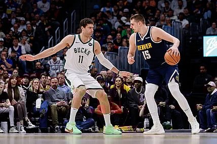 Jan 29, 2024; Denver, Colorado, USA; Denver Nuggets center Nikola Jokic (15) controls the ball as Milwaukee Bucks center Brook Lopez (11) guards in the second quarter at Ball Arena. Mandatory Credit: Isaiah J. Downing-USA TODAY Sports