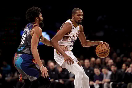 Jan 31, 2024; Brooklyn, New York, USA; Phoenix Suns forward Kevin Durant (35) controls the ball against Brooklyn Nets guard Spencer Dinwiddie (26) during the second quarter at Barclays Center. Mandatory Credit: Brad Penner-USA TODAY Sports