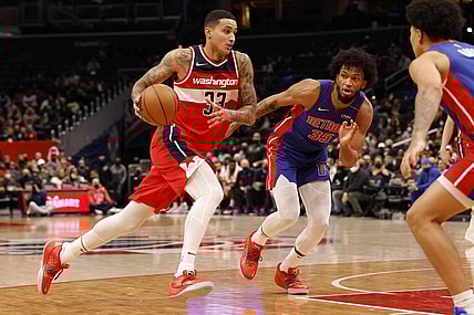 Feb 14, 2022; Washington, District of Columbia, USA; Washington Wizards forward Kyle Kuzma (33) drives to the basket past Detroit Pistons forward Marvin Bagley III (35) in the fourth quarter at Capital One Arena. Mandatory Credit: Geoff Burke-USA TODAY Sports