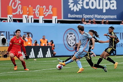 Jun 17, 2023; New York, New York, USA; New York City FC forward Gabriel Segal (19) scores a goal against Columbus Crew SC goalkeeper Patrick Schulte (28) and defenders Mohamed Farsi (23) and Steven Moreira (31) during the second half at Yankee Stadium. Mandatory Credit: Brad Penner-USA TODAY Sports