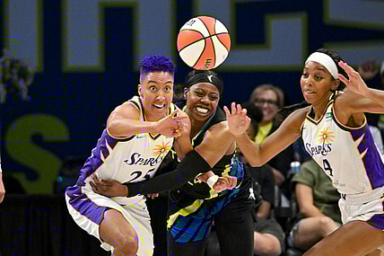 Jul 22, 2023; Arlington, Texas, USA; Los Angeles Sparks guard Layshia Clarendon (25) and guard Lexie Brown (4) and Dallas Wings guard Arike Ogunbowale (24) battle for the loose ball during the second half at College Park Center. Mandatory Credit: Jerome Miron-USA TODAY Sports