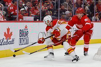 Oct 22, 2023; Detroit, Michigan, USA;  Calgary Flames center Elias Lindholm (28) and Detroit Red Wings defenseman Moritz Seider (53) battle for the puck in the third period at Little Caesars Arena. Mandatory Credit: Rick Osentoski-USA TODAY Sports