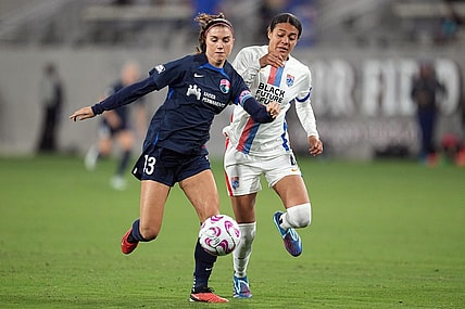 Nov 5, 2023; San Diego, California, USA;  San Diego Wave FC forward Alex Morgan (13) and OL Reign defender Alana Cook (4) battle for the ball in the second half at Snapdragon Stadium. Mandatory Credit: Ray Acevedo-USA TODAY Sports
