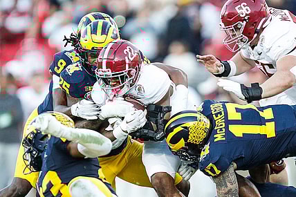 Alabama running back Justice Haynes (22) runs against Michigan defensive end Braiden McGregor (17) during the second half of the Rose Bowl in Pasadena, Calif., on Monday, Jan. 1, 2024.