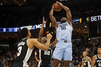 Jan 2, 2024; Memphis, Tennessee, USA; Memphis Grizzlies center Bismack Biyombo (18) collects a rebound over San Antonio Spurs guard Malaki Branham (22) during the first half at FedExForum. Mandatory Credit: Petre Thomas-USA TODAY Sports
