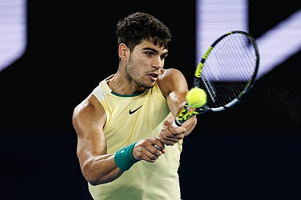 Jan 24, 2024; Melbourne, Victoria, Australia; Carlos Alcaraz of Spain in action against Alexander Zverev of Germany in the quarter final of the men s singles at the Australian Open. Mandatory Credit: Mike Frey-USA TODAY Sports