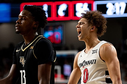 Cincinnati Bearcats guard Dan Skillings Jr. (0) reacts to hitting a 3-point basket over UCF Knights forward Marchelus Avery (13) to put Cincinnati Bearcats up by 5 points with under 3 minutes to play in the second half of the NCAA basketball game between Cincinnati Bearcats and UCF Knights at Fifth Third Arena in Cincinnati on Saturday, Jan. 27, 2024.