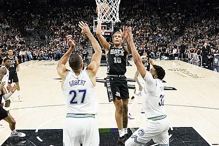 Jan 27, 2024; San Antonio, Texas, USA; San Antonio Spurs forward Jeremy Sochan (10) drives to the basket past Minnesota Timberwolves centers Rudy Gobert (27) and Karl-Anthony Towns (32) during the second half at Frost Bank Center. Mandatory Credit: Scott Wachter-USA TODAY Sports