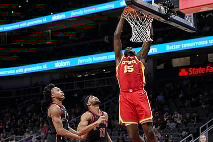 Jan 28, 2024; Atlanta, Georgia, USA; Atlanta Hawks center Clint Capela (15) dunks behind Toronto Raptors forwards Scottie Barnes (4) and Bruce Brown (11) during the first half at State Farm Arena. Mandatory Credit: Dale Zanine-USA TODAY Sports