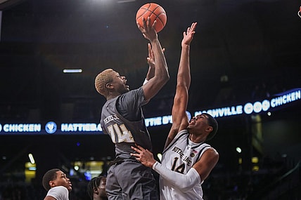 Jan 9, 2024; Atlanta, Georgia, USA; Georgia Tech Yellow Jackets guard Kowacie Reeves Jr. (14) shoots over Notre Dame Fighting Irish forward Kebba Njie (14) in the second half at McCamish Pavilion. Mandatory Credit: Brett Davis-USA TODAY Sports